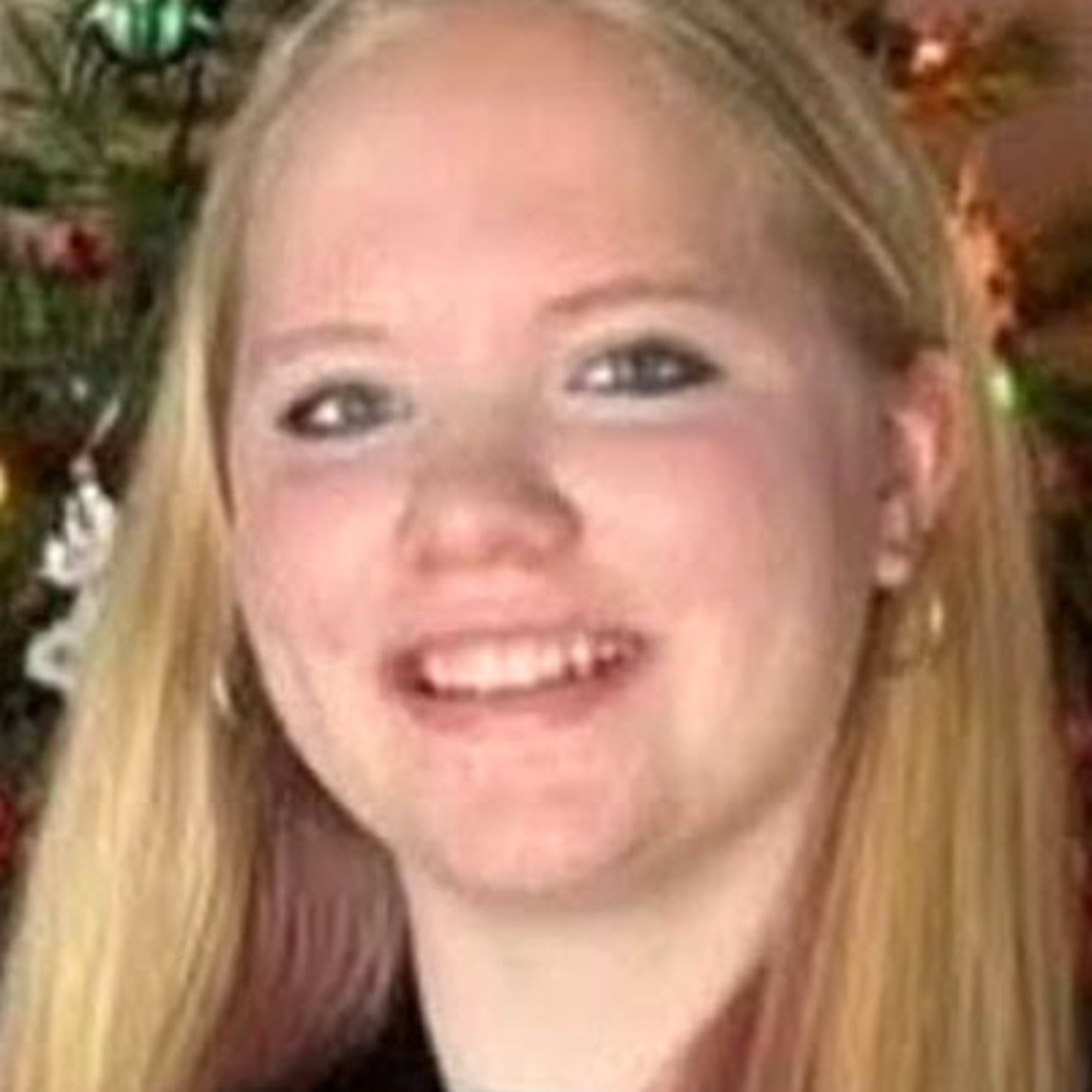 Autumn Jackson. Missing child with blonde hair and blue eyes. In this photo, she is wearing gold hoops and her hair down.